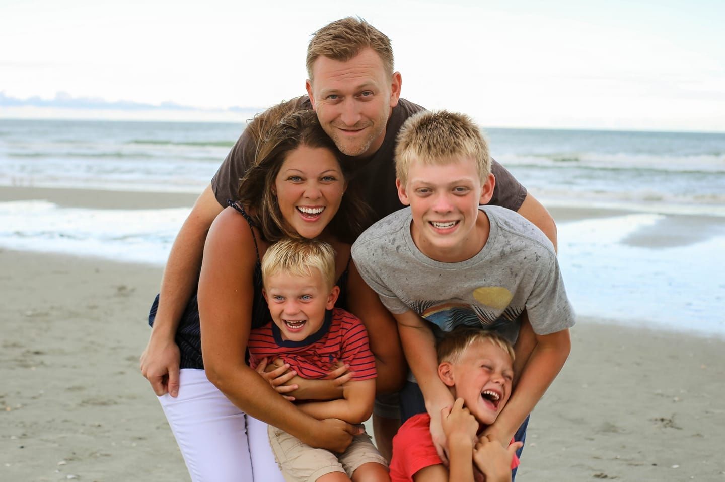 Photographer bio picture with family at the beach.