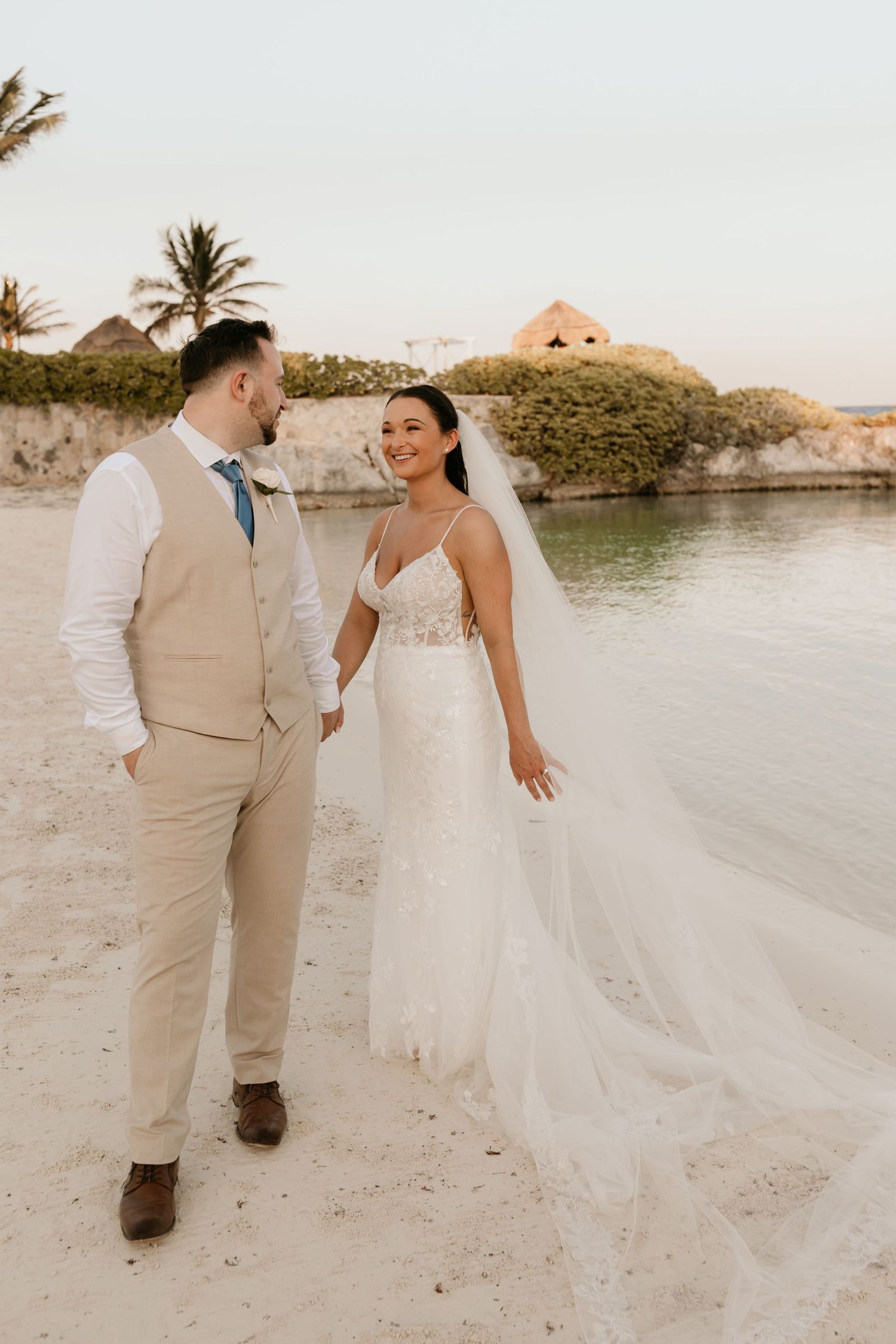 A beachside wedding scene with palm trees and white sand creating a romantic tropical backdrop.