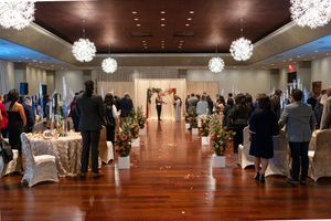 Spacious wedding reception venue with hardwood floors and hanging crystal ball decorations.