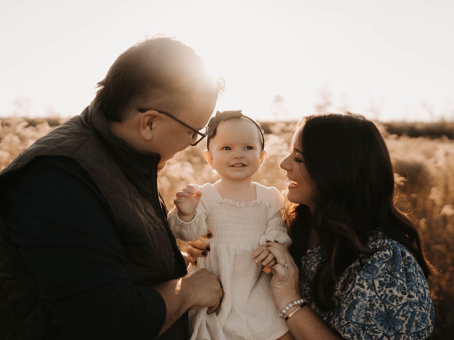 Romantic sunset engagement photos with a couple and their dog in a park setting.
