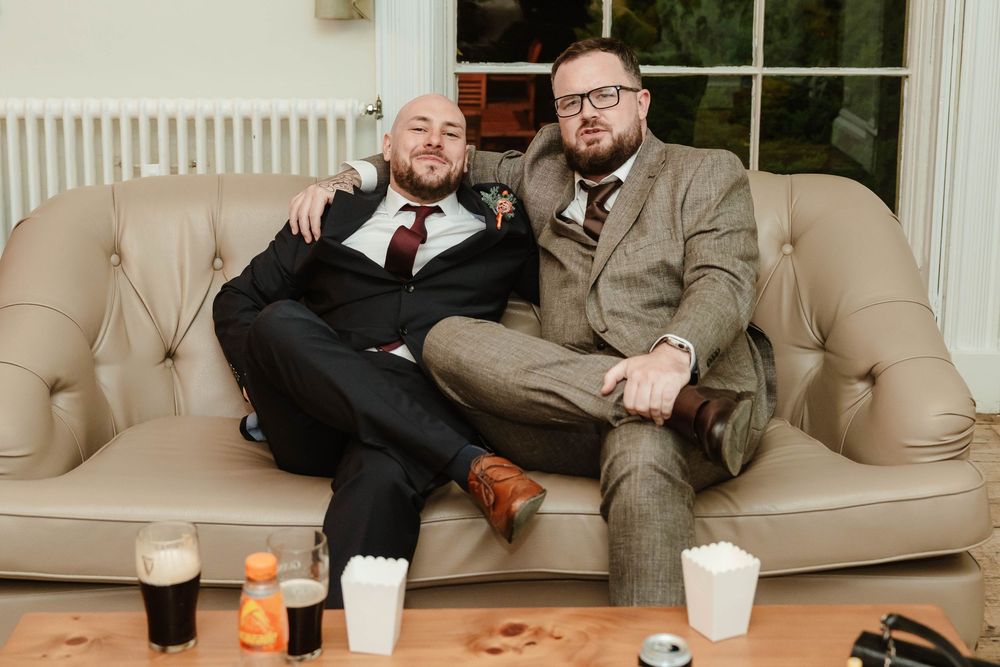 Eastington Park wedding photography Gloucestershire Evening Reception guests on the sofas