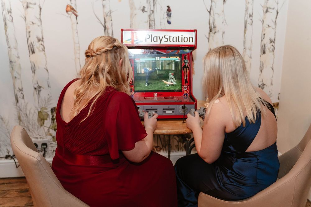 Eastington Park wedding photography Gloucestershire Evening Reception guests playing arcade games