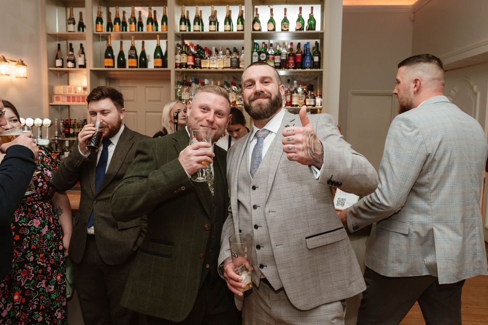 Eastington Park wedding photography Gloucestershire Evening Reception guests at the bar