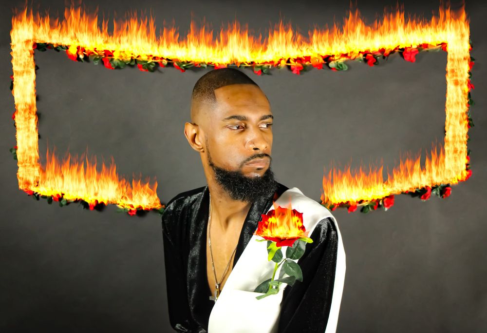 Artistic portrait with floral details and fire border effects in dark setting.
