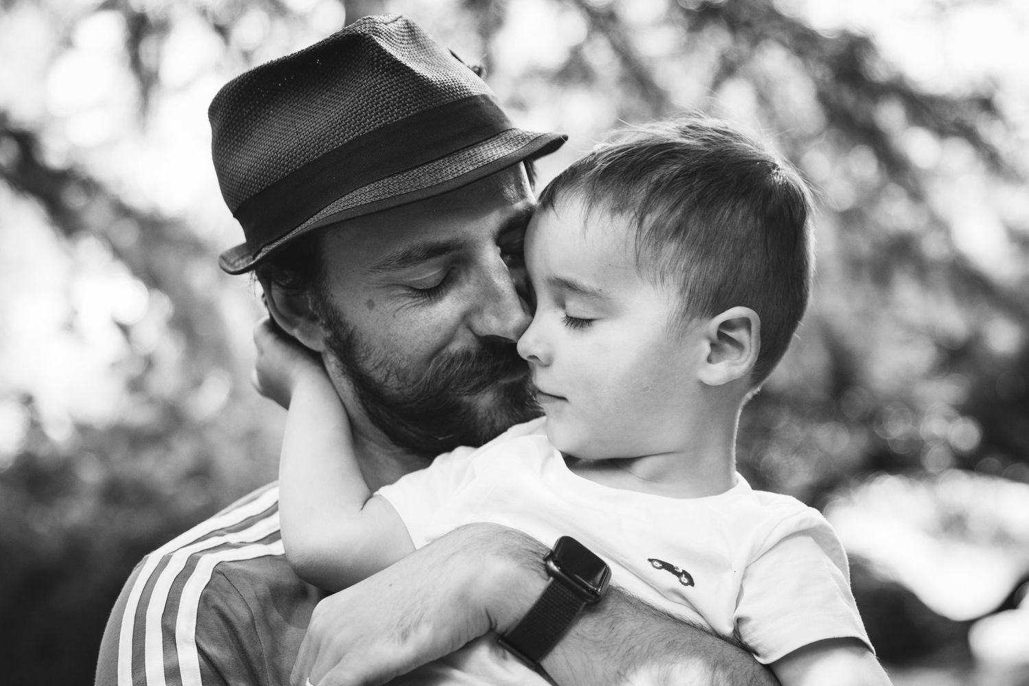 An intimate black and white portrait showing a gentle moment of connection.