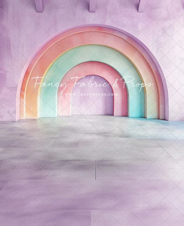 Pastel rainbow arch photography backdrop with purple quilted walls and gray tiled floor by Fancy Fabric & Props.
