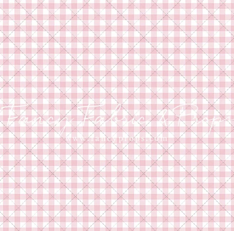Pink and white gingham check pattern fabric texture, perfect for backgrounds or craft projects.