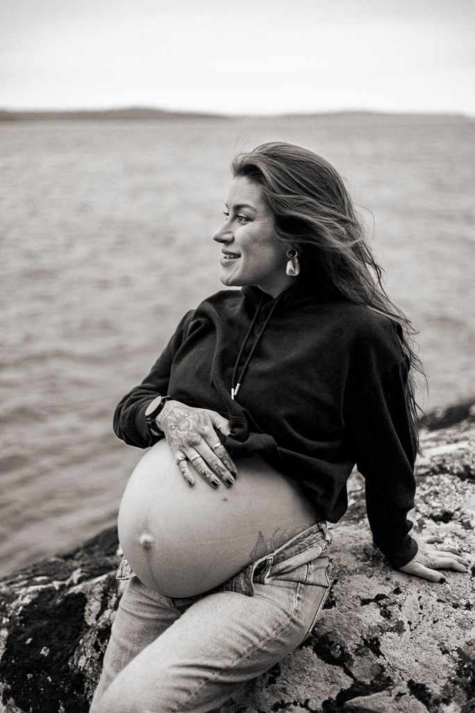A maternity photo shows an expectant mother in a green dress illuminated by golden sunlight filtering through trees.