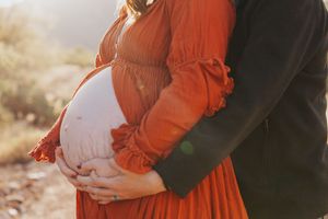 Close-up shots of a maternity photo session in warm desert lighting.