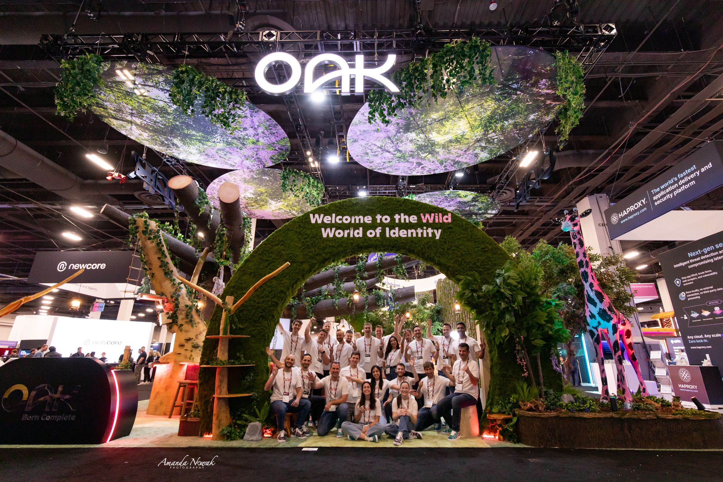 Oak brand exhibition booth with tree arch display at trade show event.