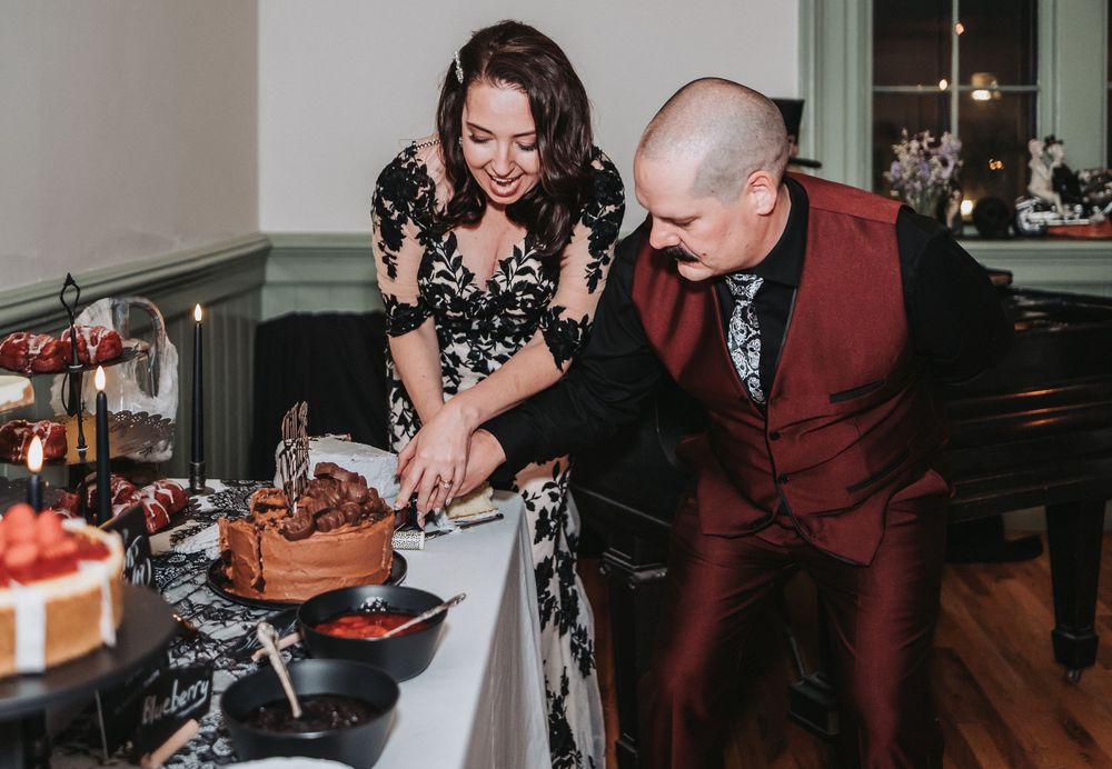 A couple in formal attire dancing together at an elegant indoor event space.