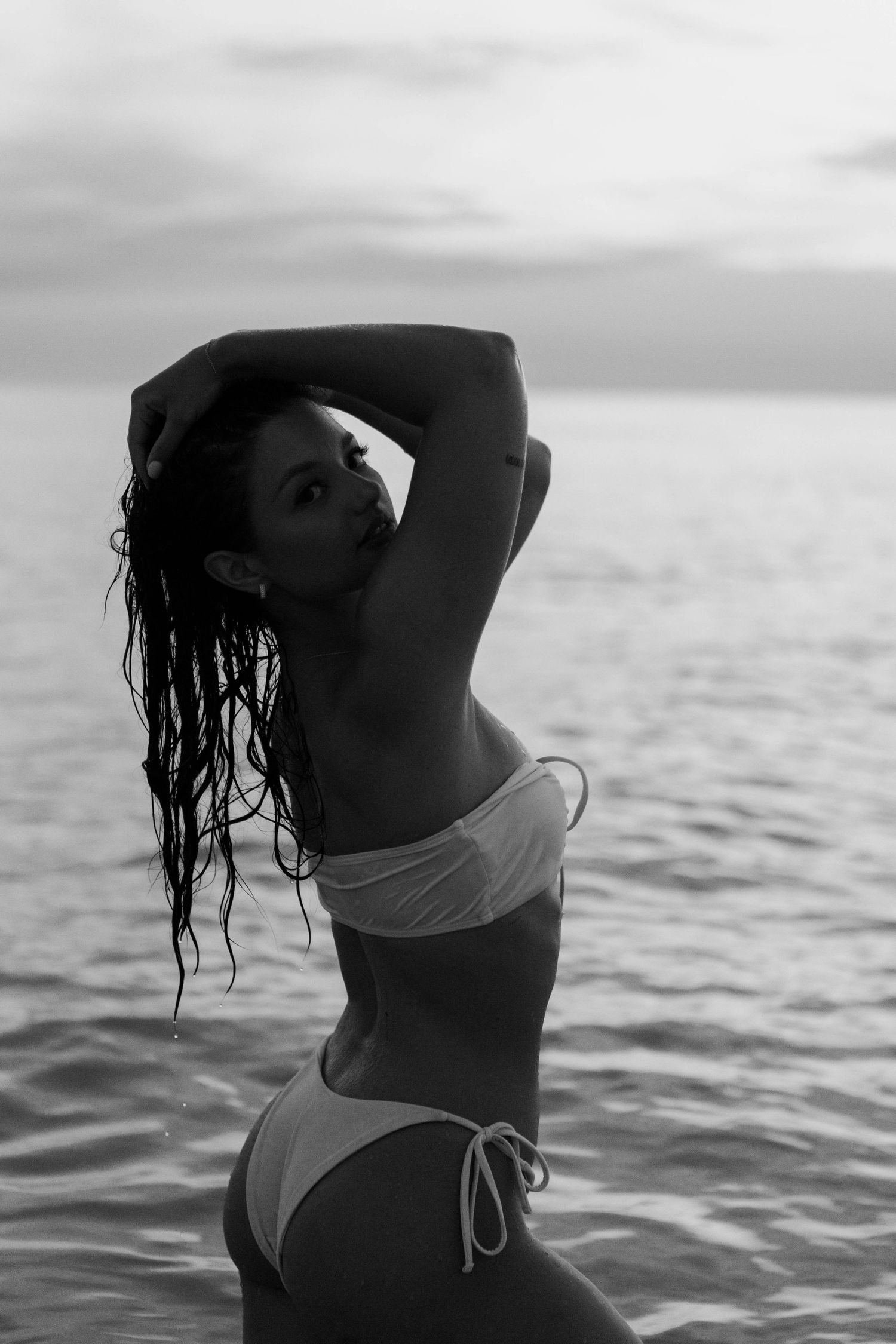 A solo session of a woman posing in the water of the ocean in Florida