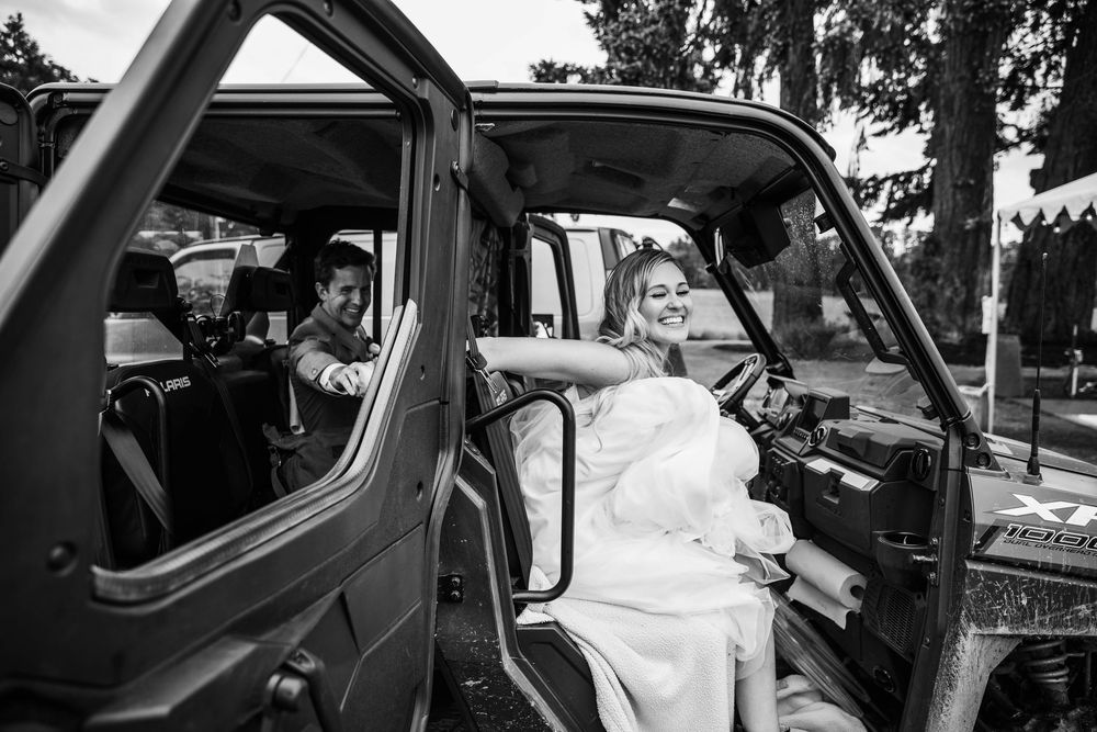 A black and white candid photo taken through a car window.