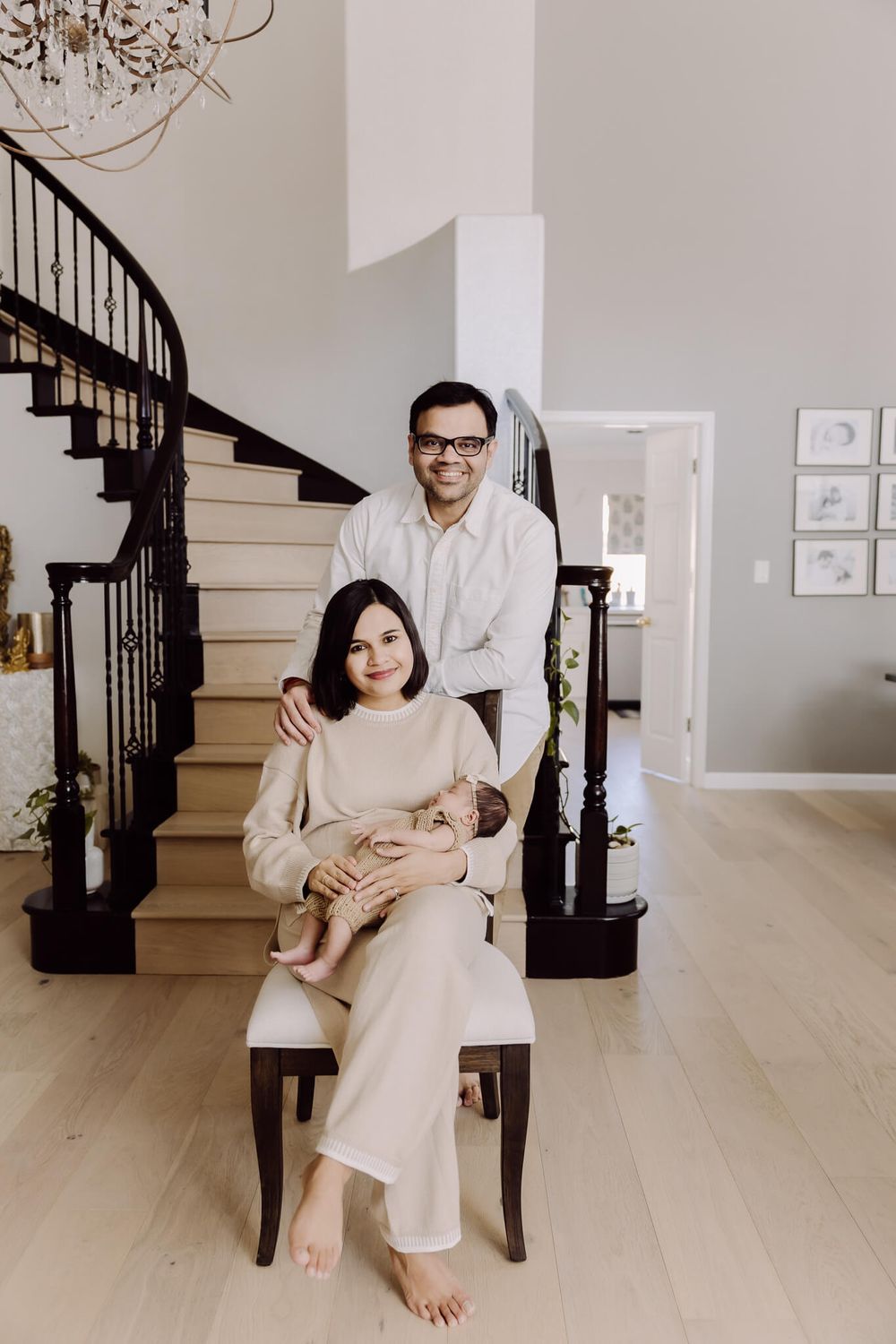 Parents holding their newborn baby in Fremont home, lifestyle newborn photography