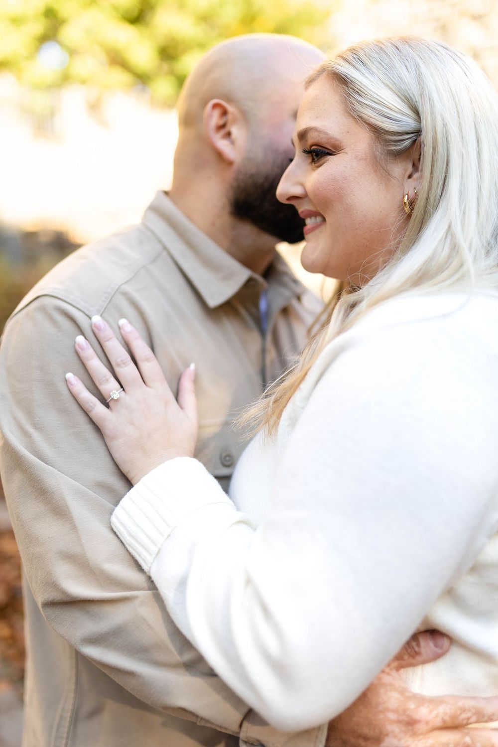 A tender romantic moment captured in warm autumn lighting.
