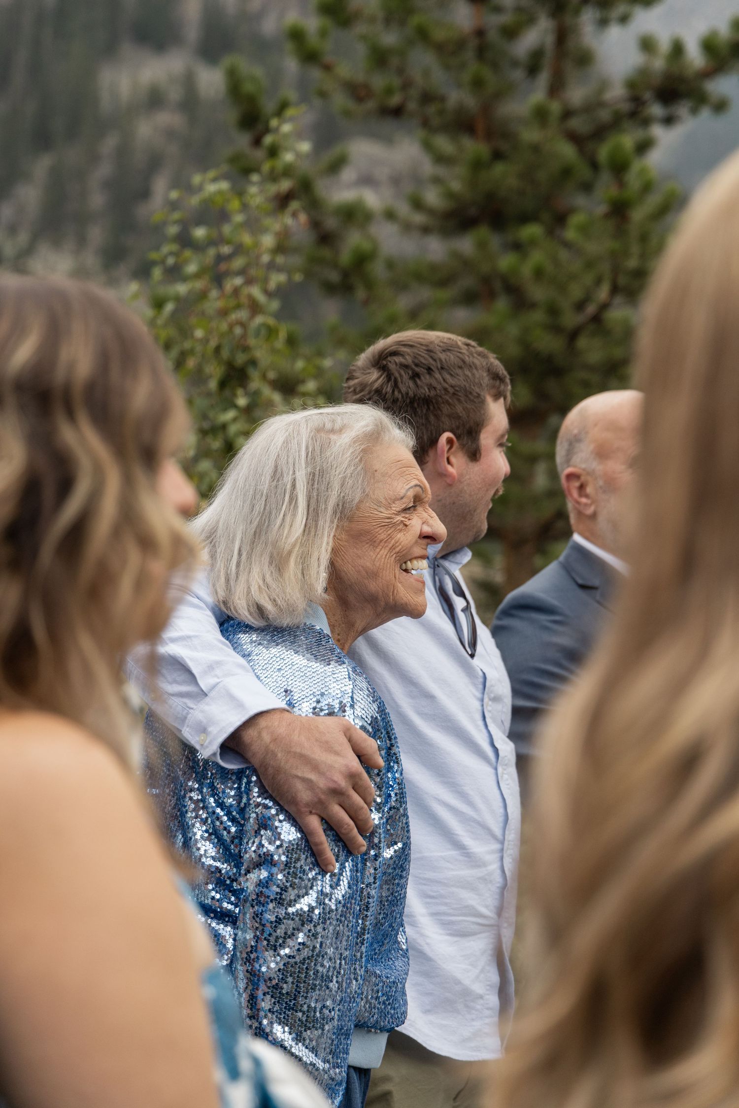 A group of people gathered outdoors in casual dress during what appears to be a social gathering or event.