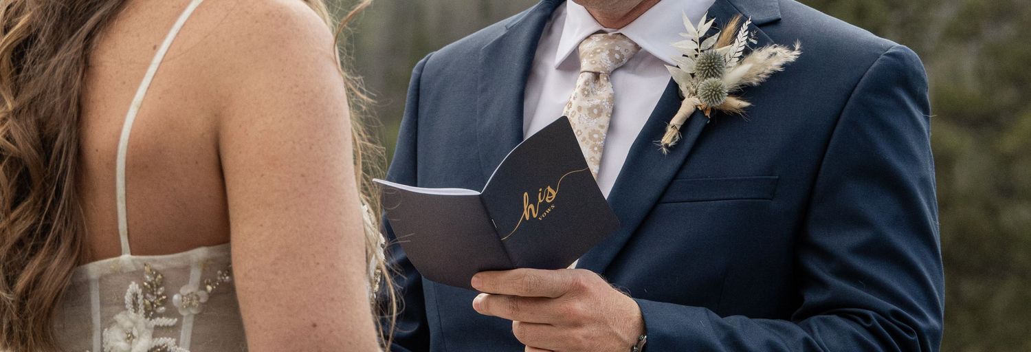 A bride and groom share an intimate moment outdoors during their wedding ceremony.