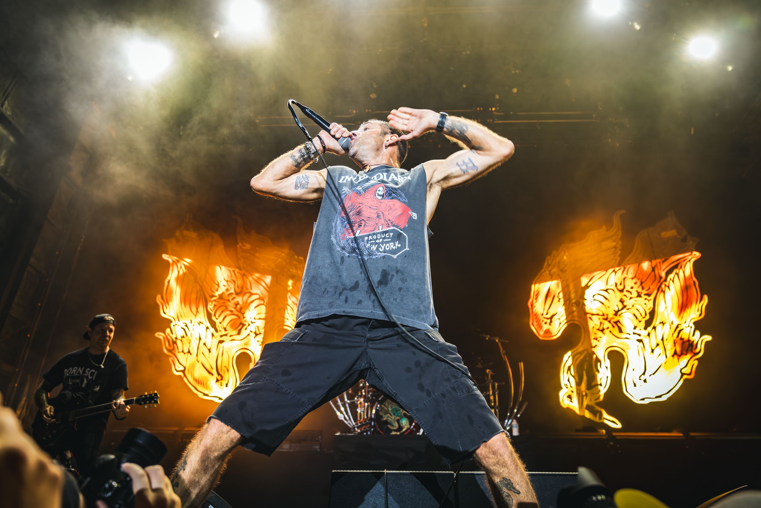 Dynamic concert performance with dramatic fire effects and lighting on stage.