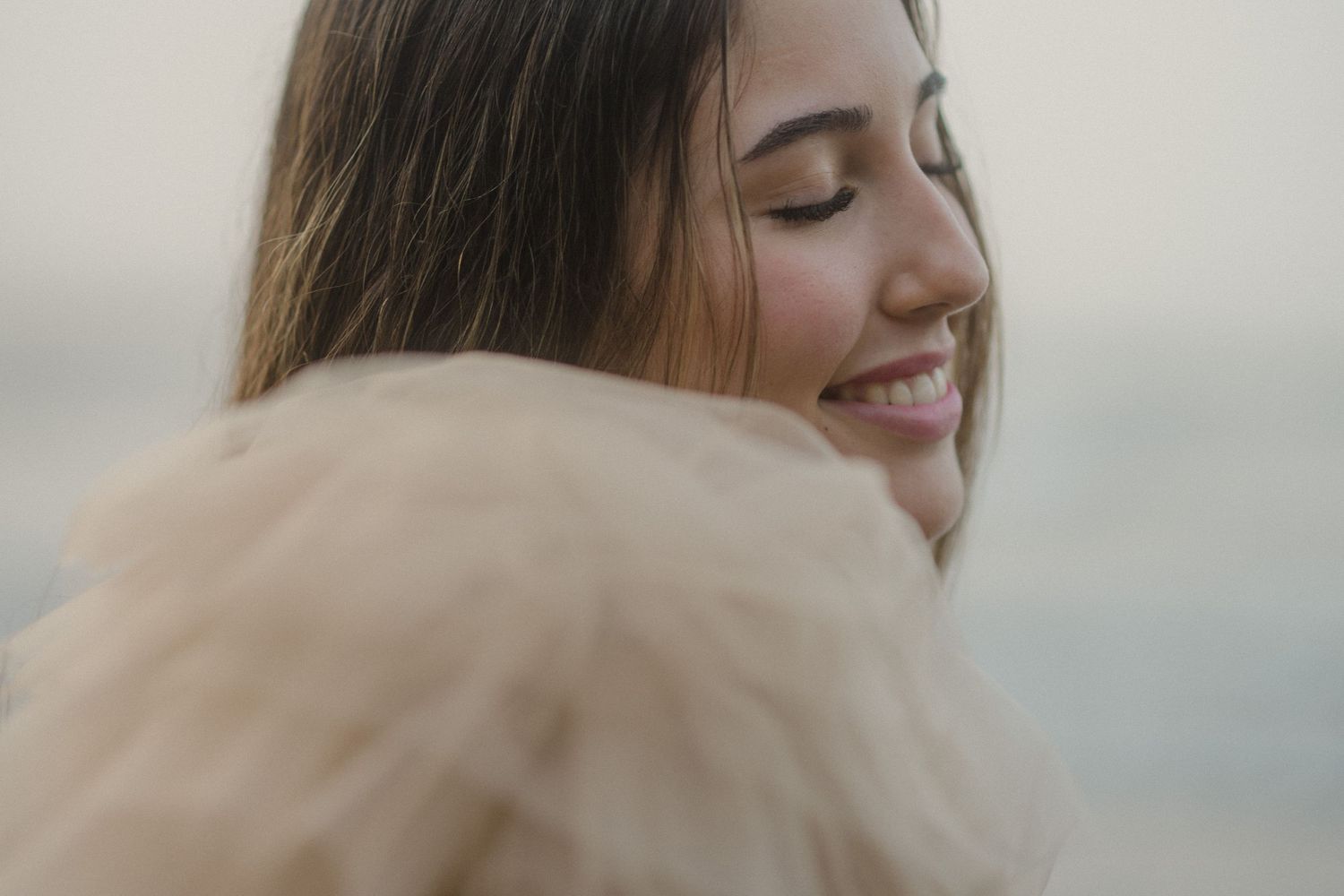 Portrait series showing gentle expressions through soft romantic lighting and tulle fabric.