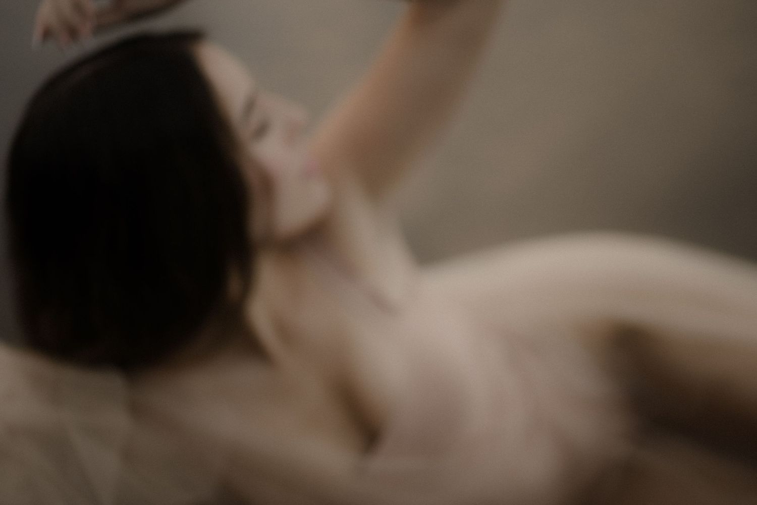 Ethereal portrait study with dramatic shadows and delicate fabric movement.