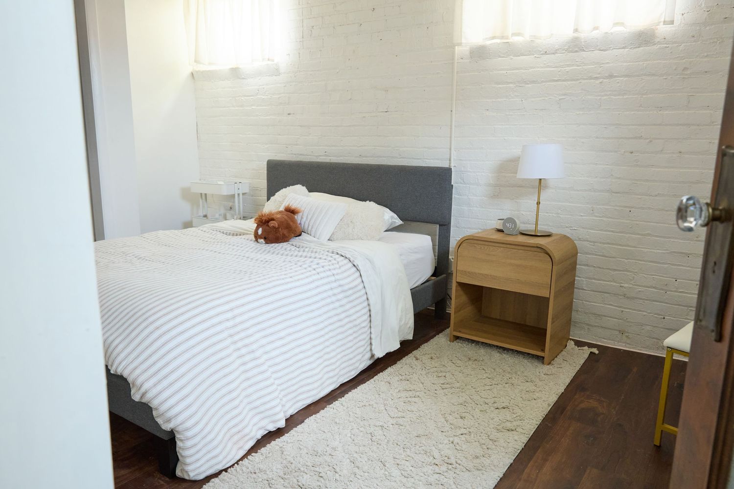 Clean white bedroom with multiple beds and minimal furnishings.