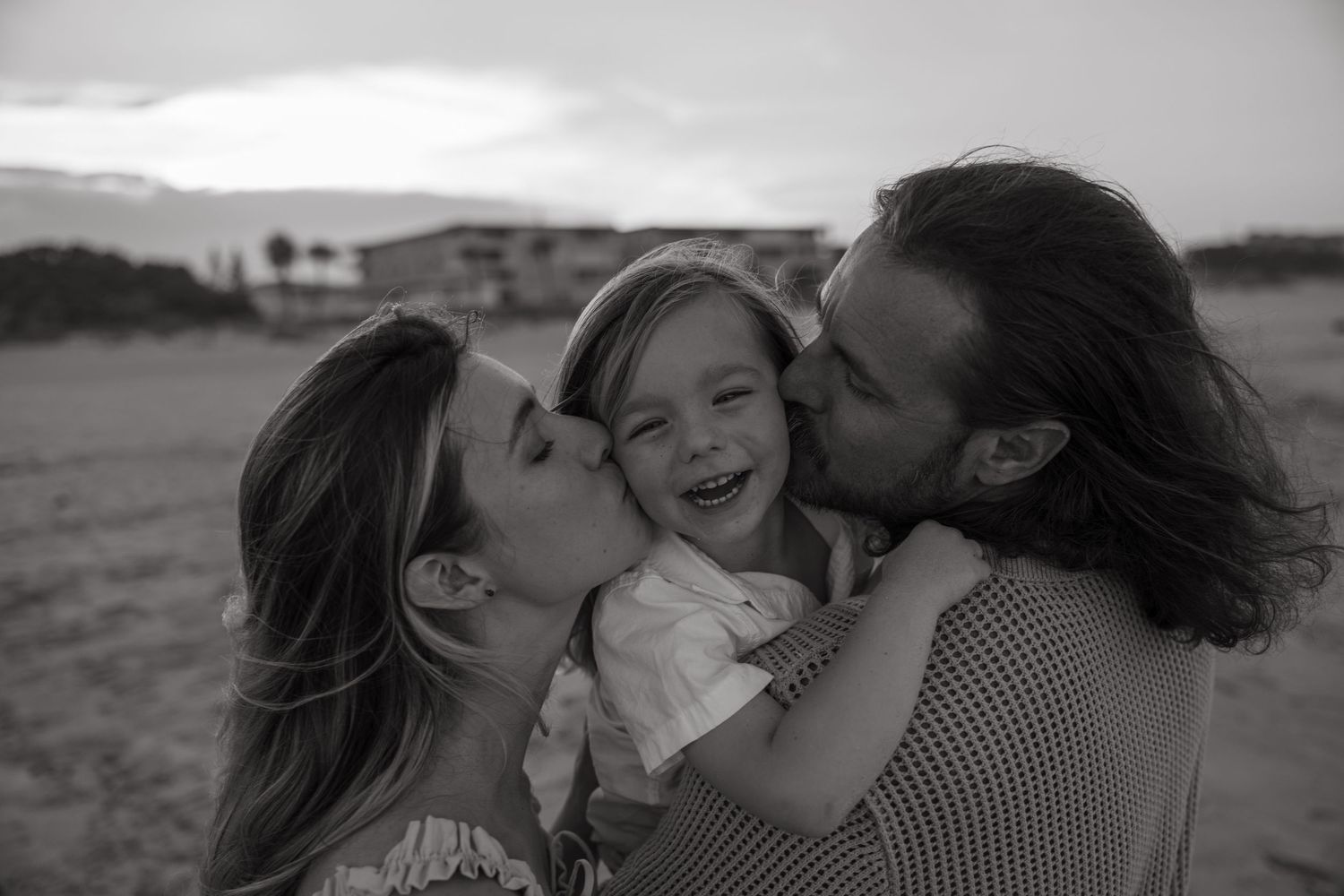 Black and white photo series of an intimate family moment showing affection and joy.