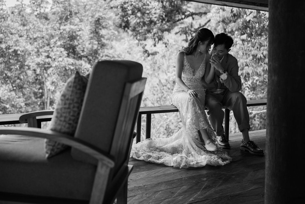 A black and white wedding photo taken in a covered outdoor space.