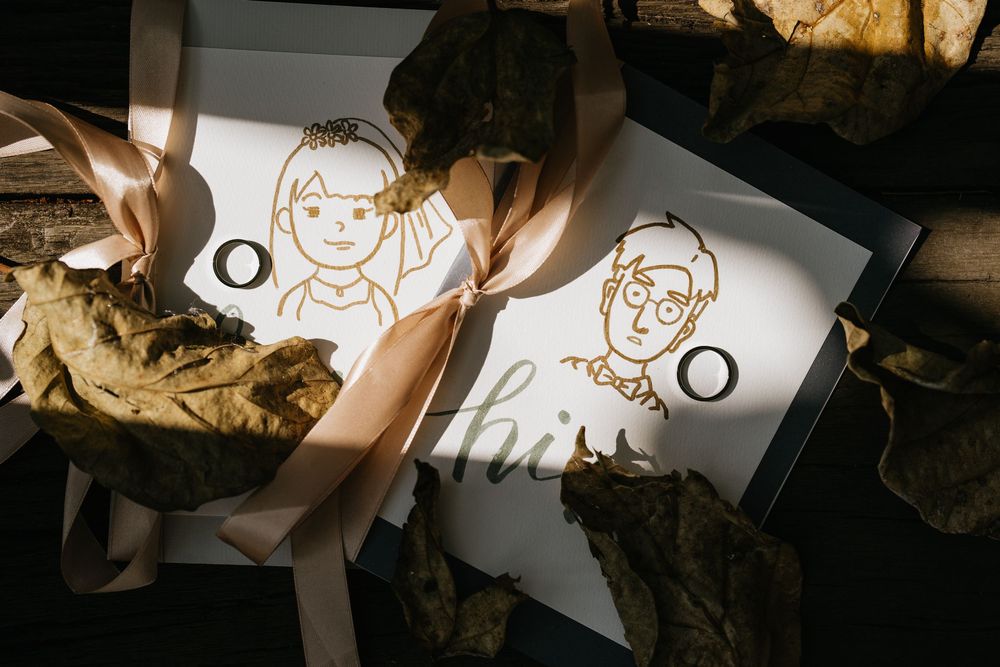 Hand-drawn cartoon illustrations on white paper cards arranged in a wedding theme.