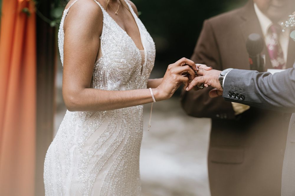 Close-up details of a lace wedding dress in natural window light.