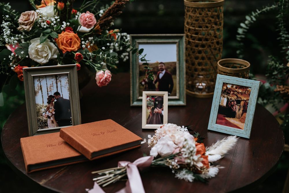 Wedding memorabilia and framed photos displayed with floral decorations.