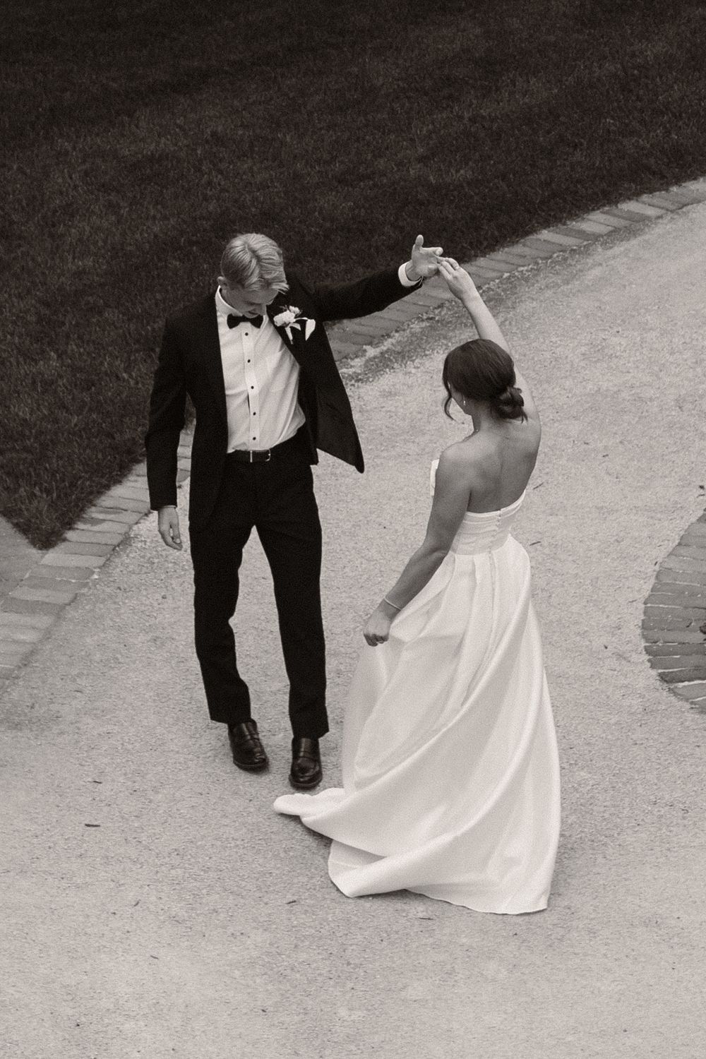 Black and white photo sequence of couple dancing on a garden path.