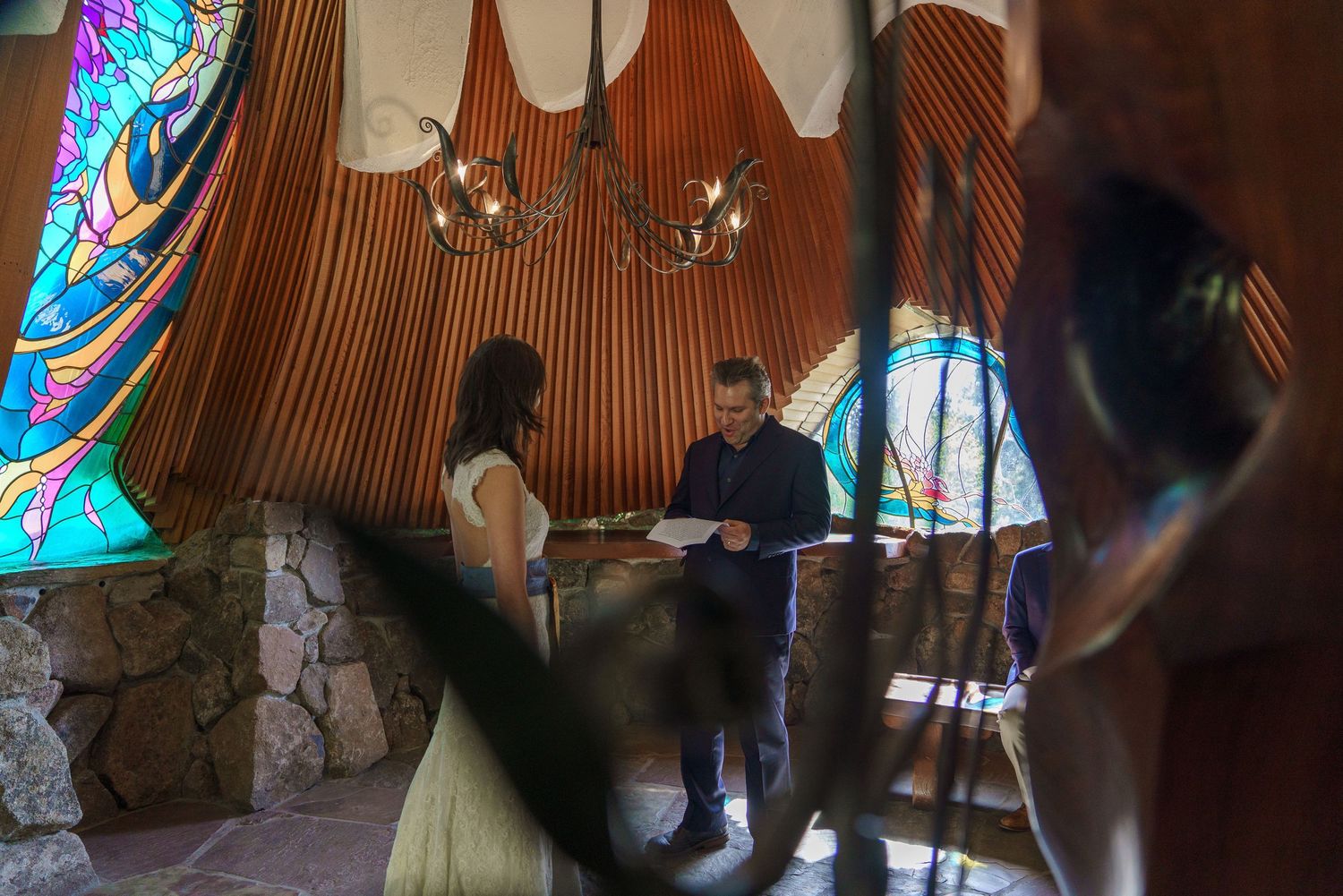 A couple exchanging vows inside the Sea Ranch Chapel