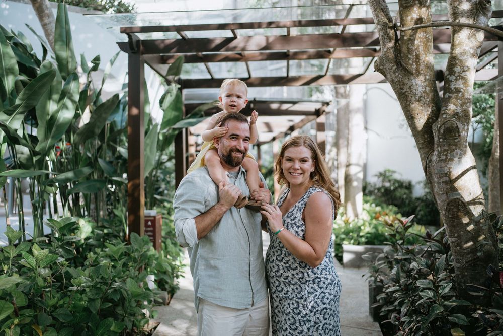Couple sharing joyful moment together in tropical garden setting.