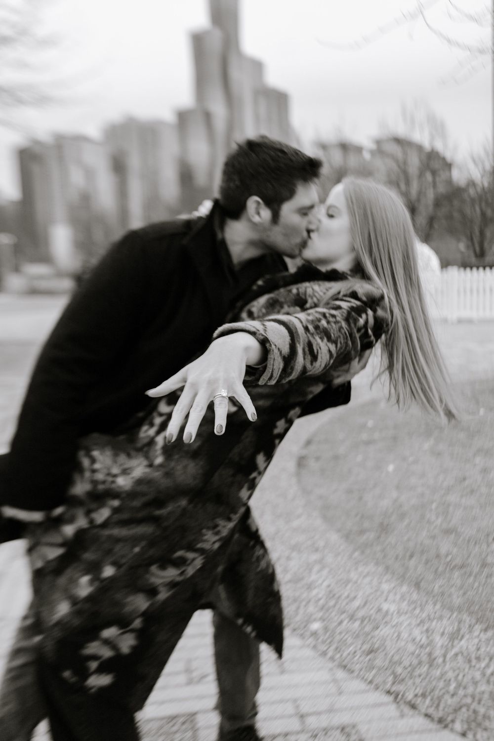 A couple shares a playful moment in a black and white photo sequence showing them leaning away then coming together.
