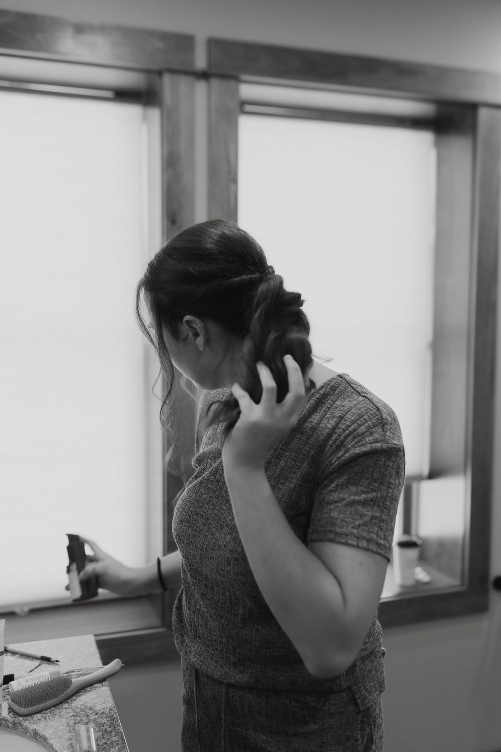 A person in a gray shirt appears emotional while looking down in a sequence of black and white photos.