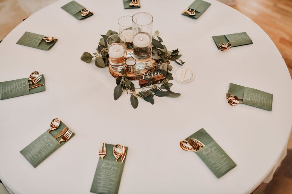 Wedding reception greenery runner with candles in glass votives at Whispering Oaks