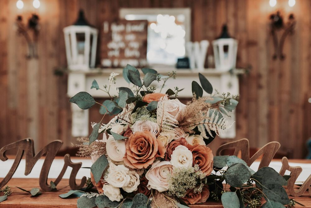 Elegant barn reception tablescape with gold accents and candles