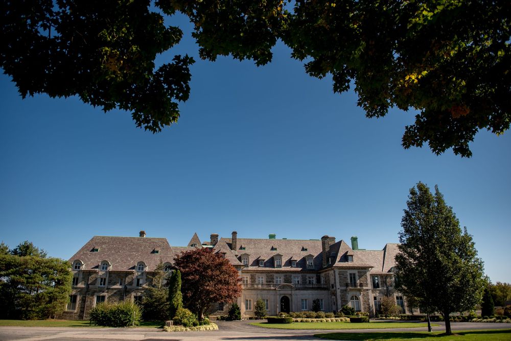 Panoramic exterior view of an elegant venue building on a sunny day.