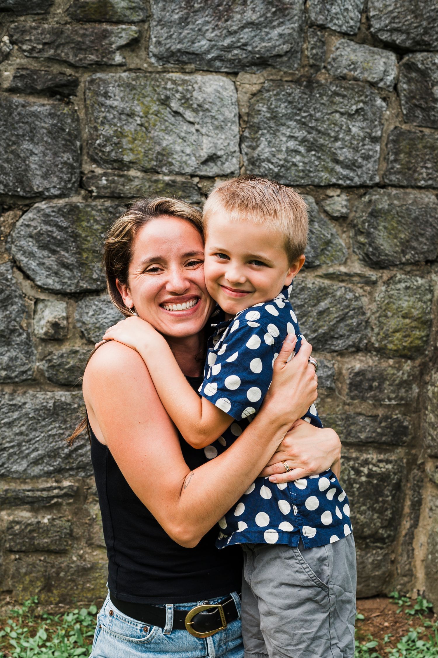 A series of candid moments captured against a stone wall background showing joyful interaction and warm embraces.