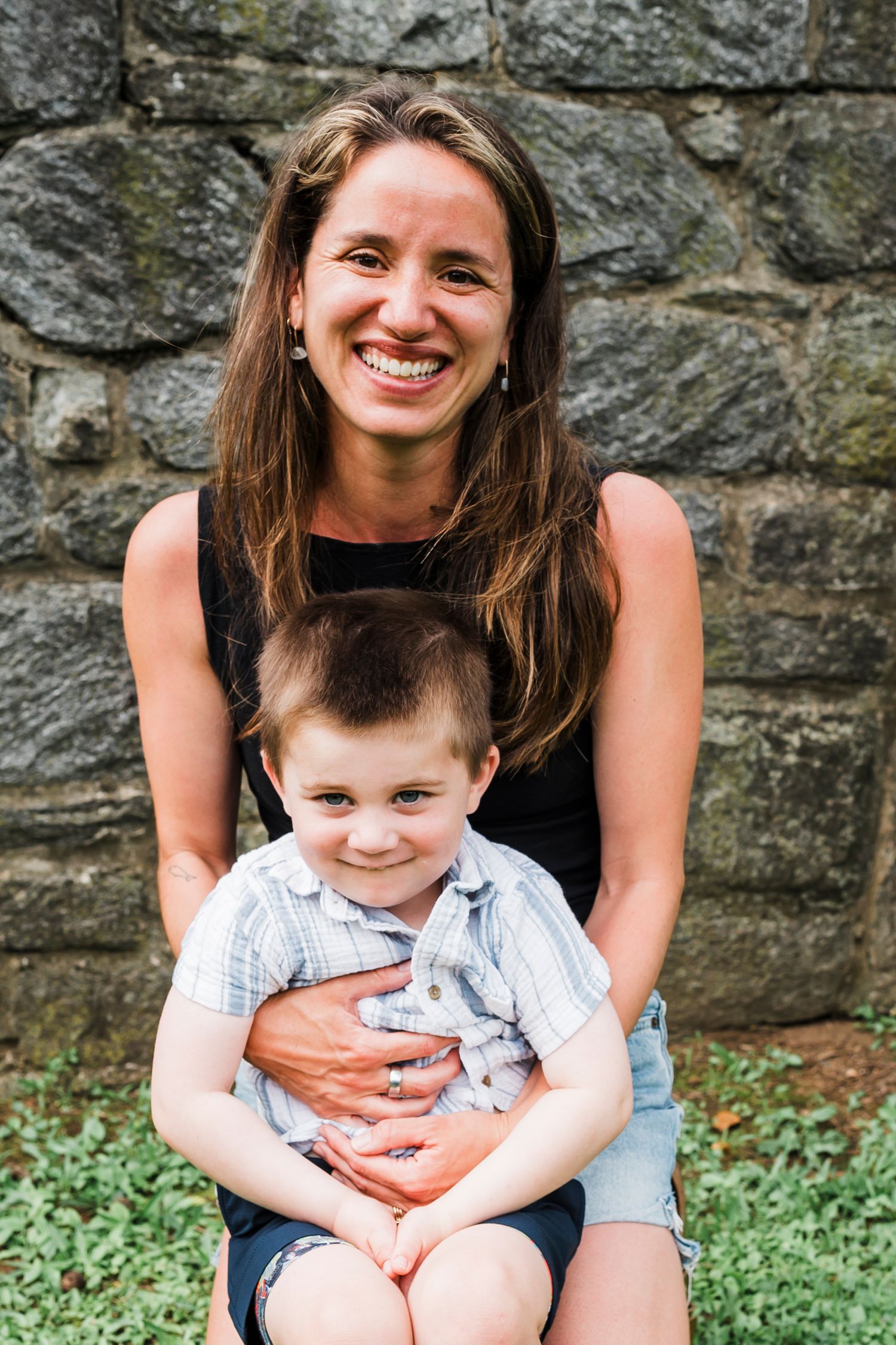 A heartwarming series of photos showing a parent and child embracing and smiling together against a stone wall backdrop.