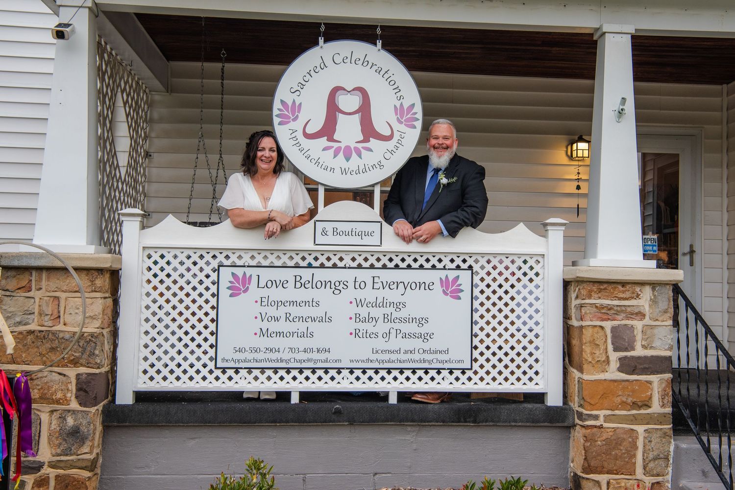 Stone building entrance with white lattice porch and decorative signage.