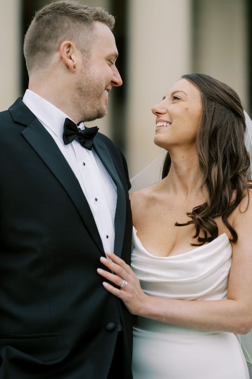 Happy bride and groom share a joyful moment together during their wedding, gazing at each other with bright smiles at Hall of Springs.