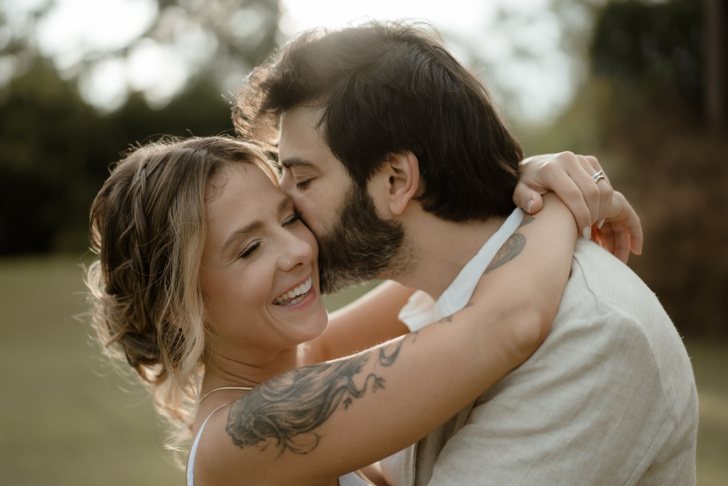 Close-up of newlyweds sharing an intimate moment in warm evening light.