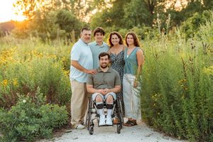 Group enjoying sunset portraits in a lush wildflower meadow during golden hour.