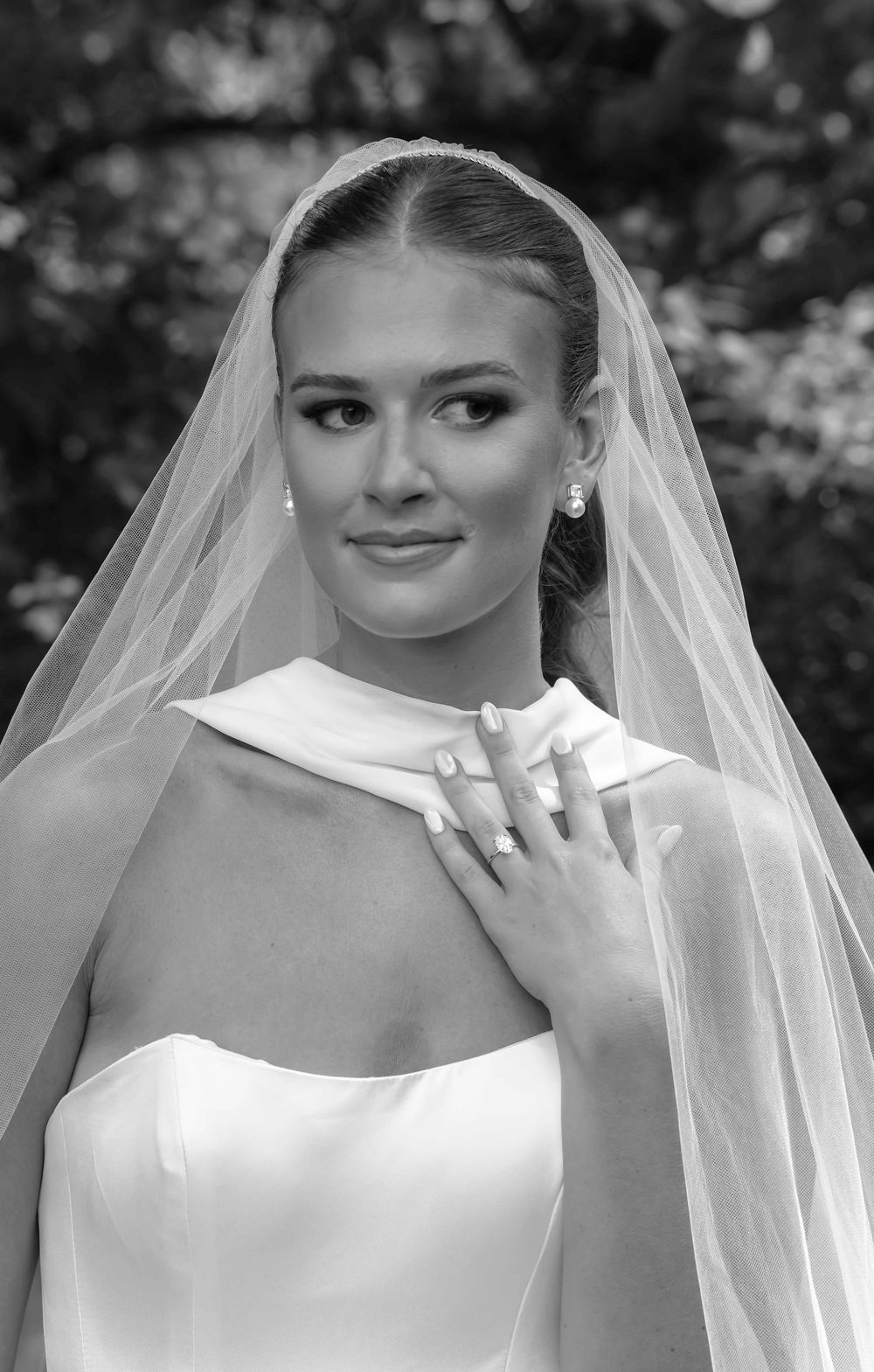 A wedding portrait collection showing a bride in an elegant white dress and delicate veil in black and white style.