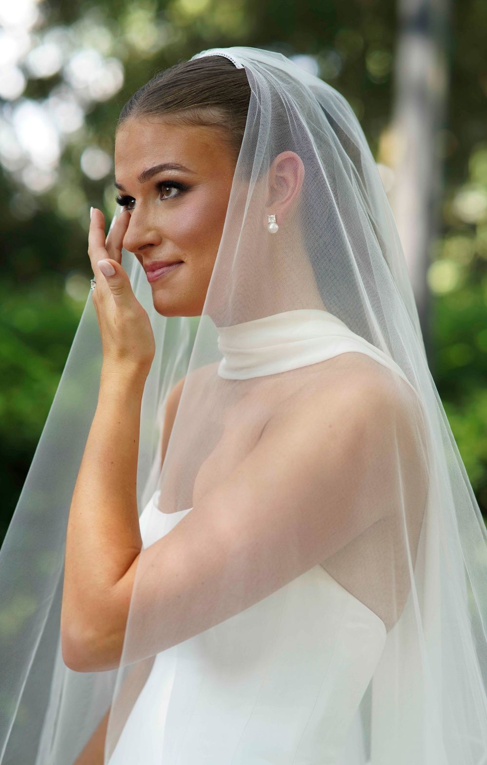 Ethereal bridal portrait sequence showing elegant veil details in an outdoor garden setting.
