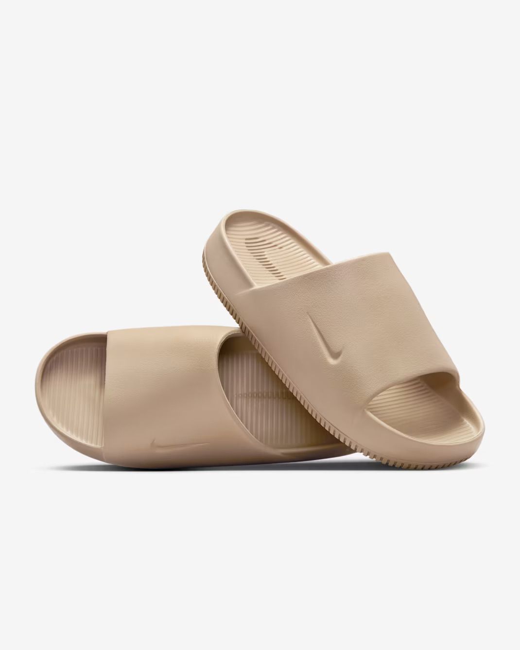 Beige rubber slide sandals with textured footbed and minimalist design shown from different angles.