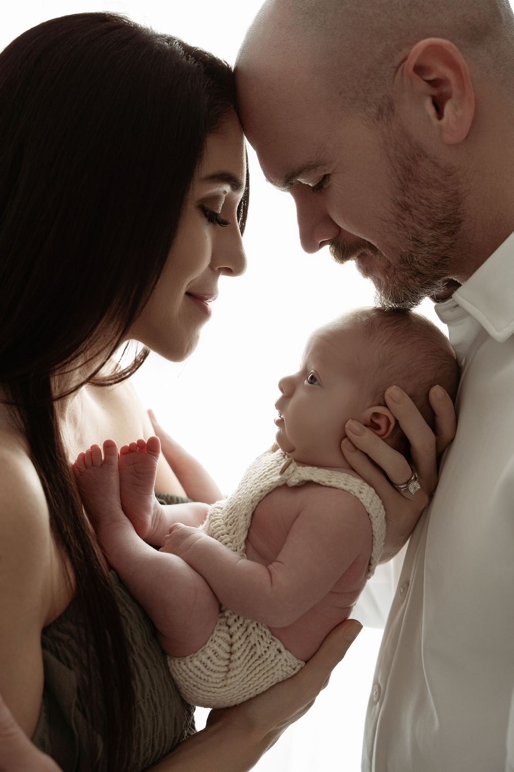 A tender moment between parents and newborn baby shown in a series of intimate black and white portraits– newborn photographer Paloma Schell