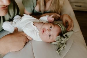 Sweet lifestyle photography of a newborn baby during an intimate home session.