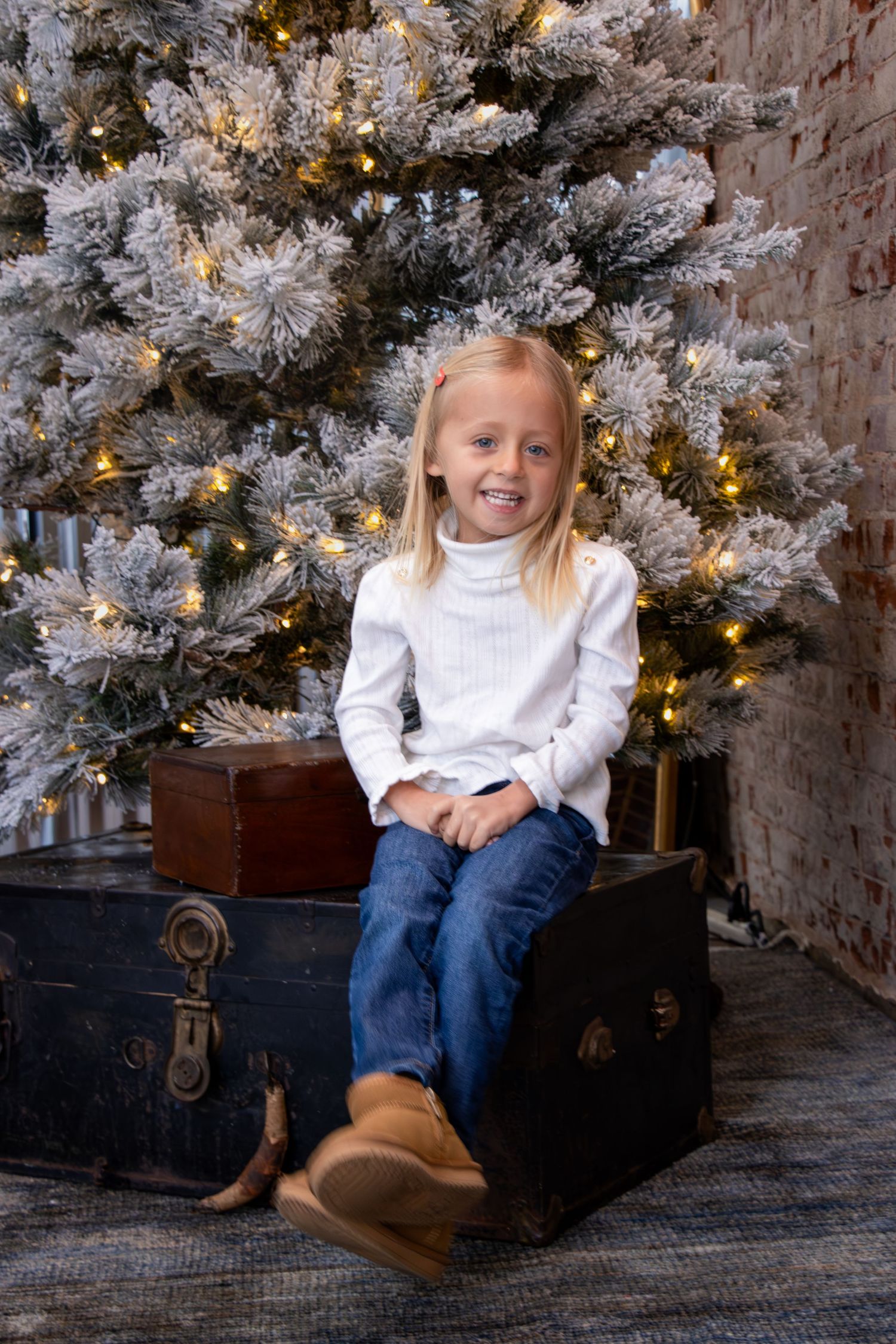 Inclusive Cincinnati family Christmas portraits of parents and daughter laughing together in a cozy holiday studio setting